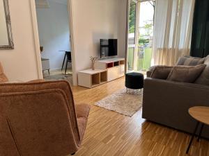 a living room with a couch and a tv at Przytulny Apartament z Balkonem Stalowa Wola in Stalowa Wola +5 photos