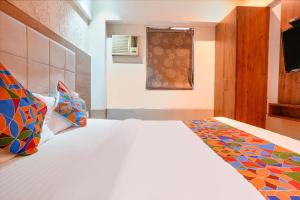 a bedroom with a bed and a window at FabHotel Regal Inn - In Sahar Road in Mumbai +29 photos