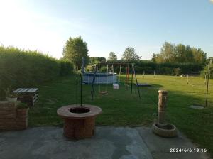 a park with a playground with a swing at Kápolnás Vendégház Báta-Gemenc in Báta