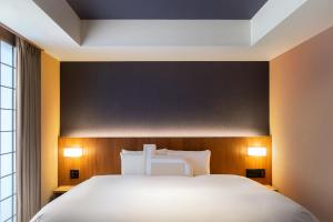 En eller flere senge i et værelse på Homm Stay Nagi Arashiyama Kyoto By Banyan Group + 16 billeder