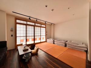 a living room with a couch and a table at Guest House WA in Kyoto