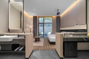 a bathroom with two sinks and a large mirror at Songmo Hotel in Huzhou