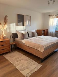 a bedroom with a large bed and a table at Schöne große Wohnung - Top Lage in Ravensburg