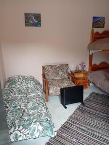 a bedroom with a bed and a chair and a pillow at Ξενώνας στα Θεοδώριανα 3 - Guesthouse Theodoriana 3 in Theodóriana +6 photos