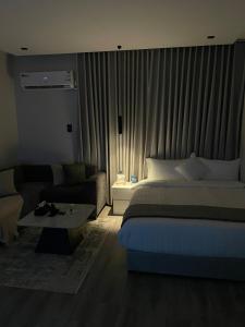 a hotel room with a bed and a couch at Studio in the resort Smart Entry in Quai +9 photos