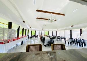 a banquet hall with tables and chairs in a room at Maota Hotel Apia in Apia