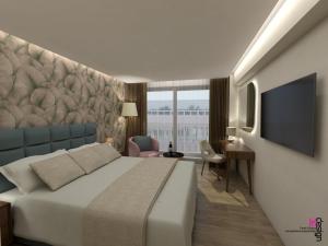 a hotel room with a large bed and a desk at Great Athens Hotel in Athens