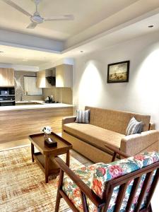 a living room with a couch and a table at Luxury Suites by Eden Wellness and Hospitality in Dehradun