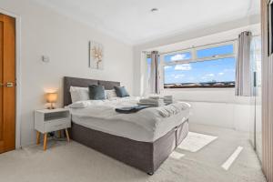 a bedroom with a large bed and a window at The Bishopsworth House in Bristol