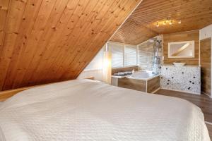 a bedroom with a white bed and a sink at Ferienwohnung Fischerhaus in Wasserburg am Bodensee