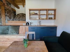a living room with a table and a kitchen at GASSERHOF Dölsach in Dölsach