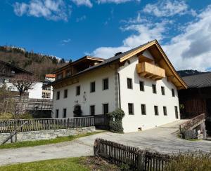 a white house with a wooden roof at GASSERHOF Dölsach in Dölsach