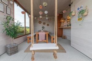 a swing in a room with a table at Lamelove Apartments - Energylandia, Zator in Chocznia