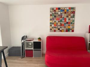 a living room with a red couch and a table at A Macina in Brando