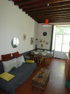 a living room with a couch and a table at Gîte de la Ferme Feugère in Barbeville