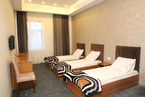 a hotel room with three beds and a chair at Arena Hotel Tartar in Terter +52 photos