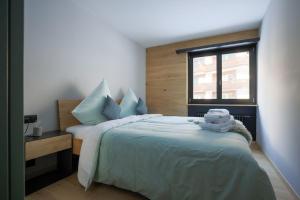 a bedroom with a bed with towels on it at Creatini Mountain in Zermatt