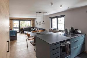 a kitchen and living room with a large island in a room at Creatini Mountain in Zermatt