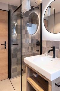 a bathroom with a sink and a shower at Creatini Mountain in Zermatt +24 photos