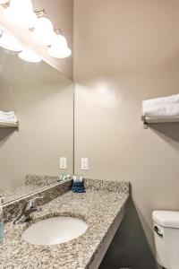 a bathroom with a sink and a mirror at Sunrise Resort Room #301 in Garden City