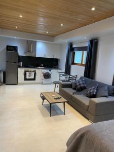a living room with a couch and a table at Mindarie beachside studio in Mindarie