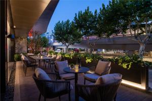 a row of tables and chairs on a patio at Intercity Hotel Shanghai City Center - Free Mini Bar in Shanghai