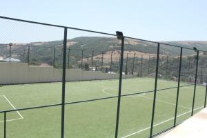 a tennis court seen through a chain link fence at Arena Hotel Yardimli in Kabakhdibi