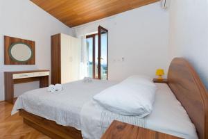 una camera da letto con un letto grande con testiera in legno di A Minute to the Sea Brela a Brela