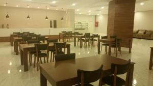 a restaurant with tables and chairs in a room at Arena Hotel Yardimli in Kabakhdibi
