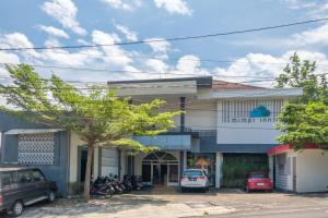 a building with cars parked in front of it at INNCA Telaga Bodas, Semarang in Jatingaleh