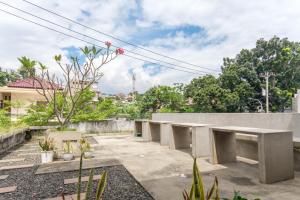 a row of concrete benches in a garden at INNCA Telaga Bodas, Semarang in Jatingaleh +27 photos