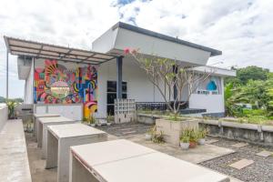 a restaurant with a mural on the side of a building at INNCA Mimpi Inn, Semarang in Jatingaleh