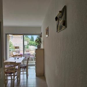 Una cocina y un comedor con mesa y sillas. en Studio avec terrasse 2 personnes, en Le Lavandou