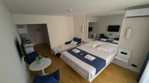 a hotel room with a large bed and a mirror at Orbi City, block C in Batumi