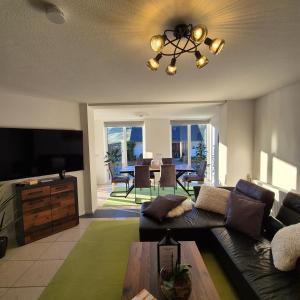 a living room with a couch and a flat screen tv at Ferienwohnung Goldrausch in Bernkastel-Kues