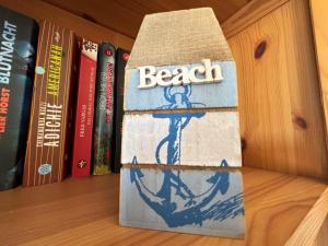 una caja en un estante con libros en Tief 10 Meeresbrise 402, en Wangerland