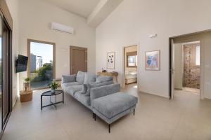 a living room with a couch and a chair at Evilion Island Residence in Ixia
