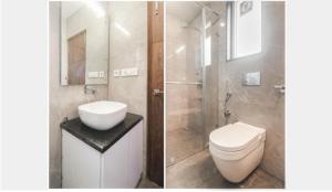 a bathroom with a toilet and a sink and a shower at Hotel Mussoorie Heights in Dehradun