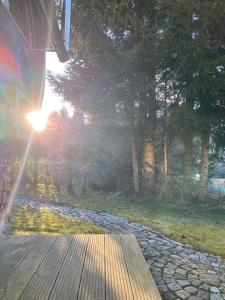 a sun shining on a path with trees in the background at far away from Africa in Steinach +3 photos