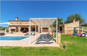 a group of lounge chairs under a canopy by a pool at Villa Lorenzo Manacor by PriorityVillas in Manacor