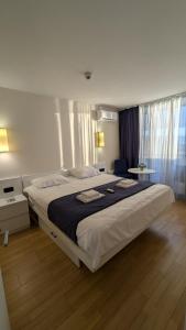 a bedroom with a large bed with two towels on it at Orbi City, block C in Batumi