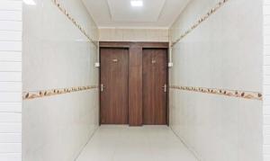 a corridor with a wooden door in a building at OYO 77138 Shree Apartments in Khadki
