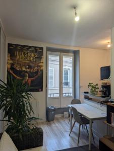 a living room with a desk and a table at Les jardins de Beauverger in Le Mans +18 photos