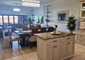 a kitchen and dining room with a table and chairs at Bona Bali 14, Zimbali Estate by Euphoric Leisure in Ballito