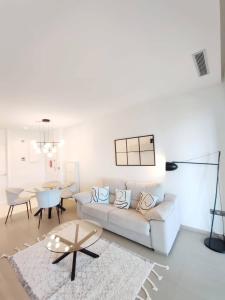 a living room with a white couch and a table at Intempo Sea Views by Agencia Poniente in Benidorm