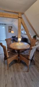 a wooden table with wicker chairs in a room at Moselhof in Burg