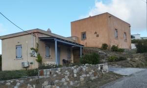 an old building with smoke coming out of it at Attik Residencies in Livadi