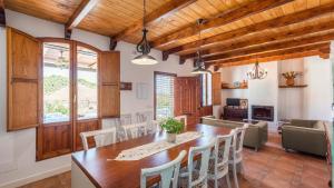 a dining room with a wooden table and chairs at Casa La Estrella Azul Vélez-Málaga by Ruralidays in Vélez-Málaga