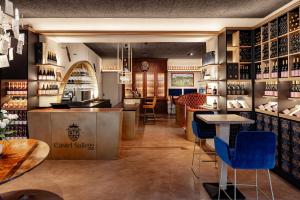 a wine tasting room with blue chairs and tables at Castel Sallegg Suites Adults only in Caldaro