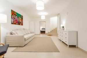 a white living room with a couch and a dresser at Berlin Mitte I 2 doule beds I fast wifi in Berlin